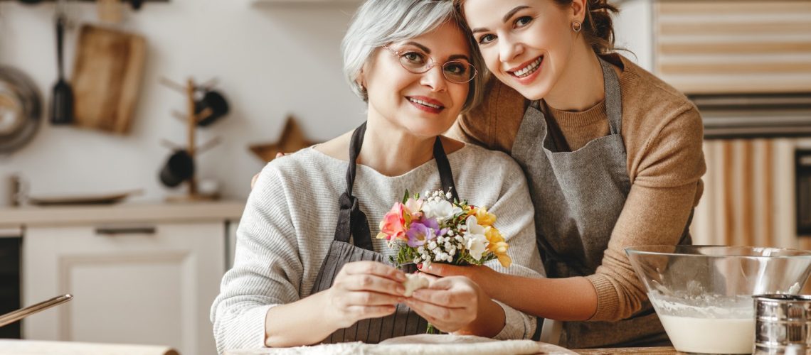 happy mother's day! family old grandmother mother-in-law and daughter-in-law daughter congratulate on the holiday, give flowers