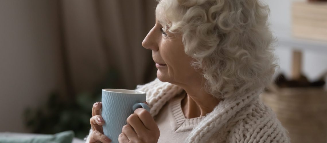 Happy,Elderly,60s,Woman,Sit,On,Sofa,In,Living,Room